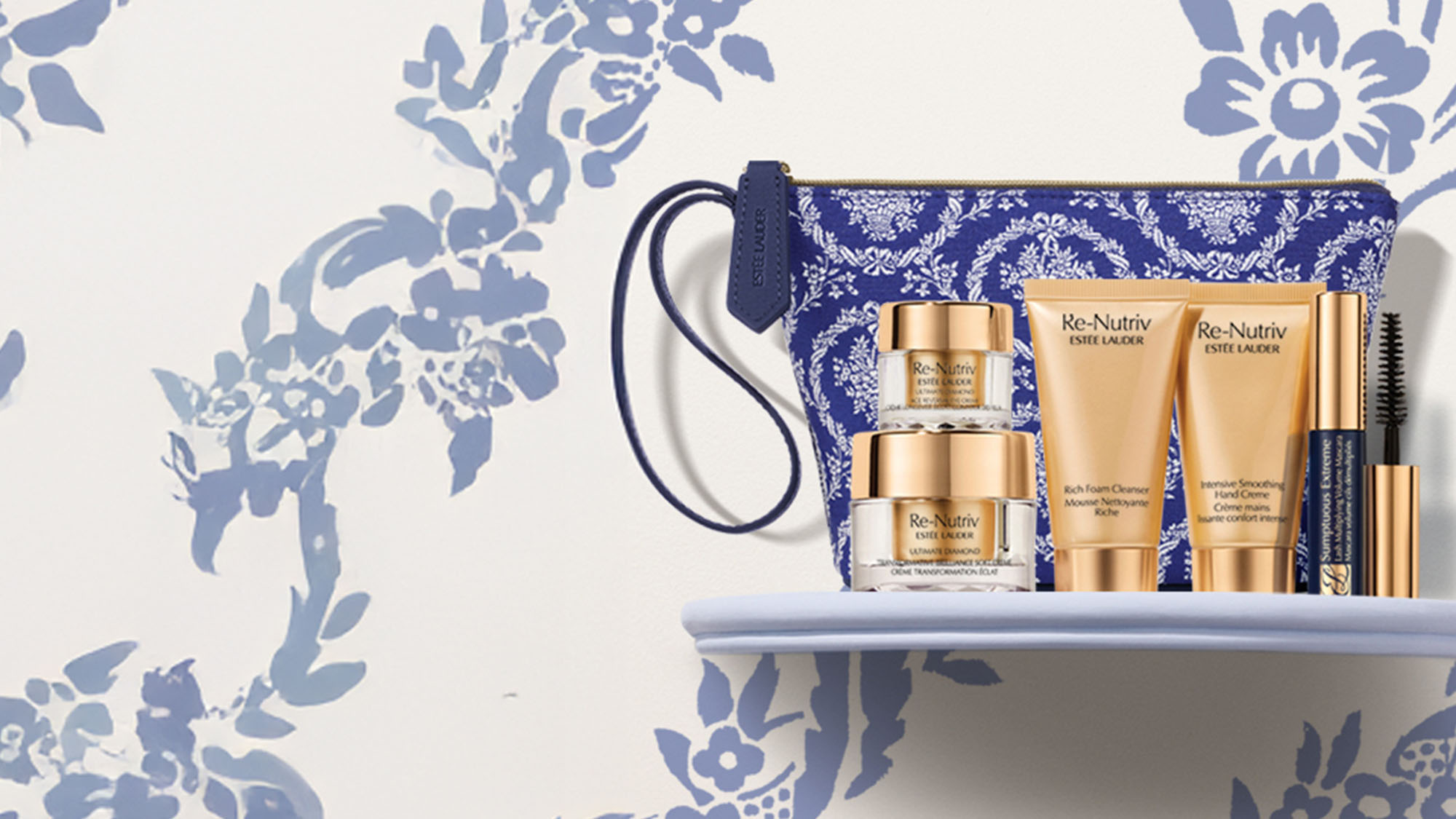 Estee Lauder Re-Nutriv skincare set with a floral pouch, displayed on a shelf against a floral-patterned background.