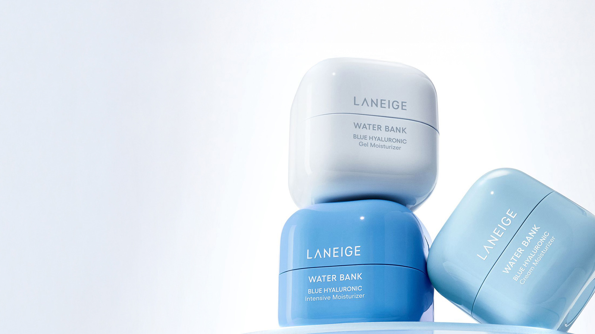 Three Laneige Water Bank moisturizers in blue and white containers, stacked on a light background.