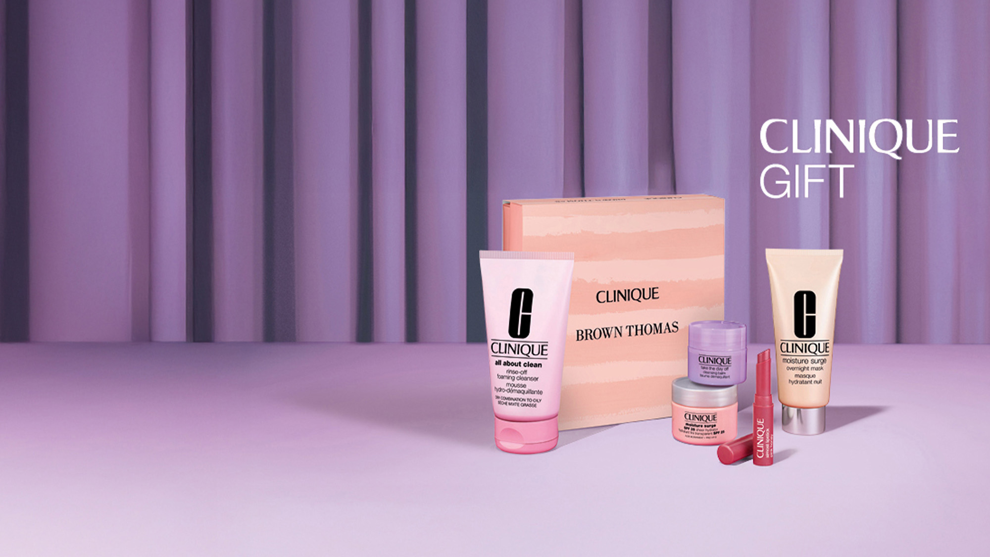 Clinique gift set featuring skincare products and lipstick with a branded box.