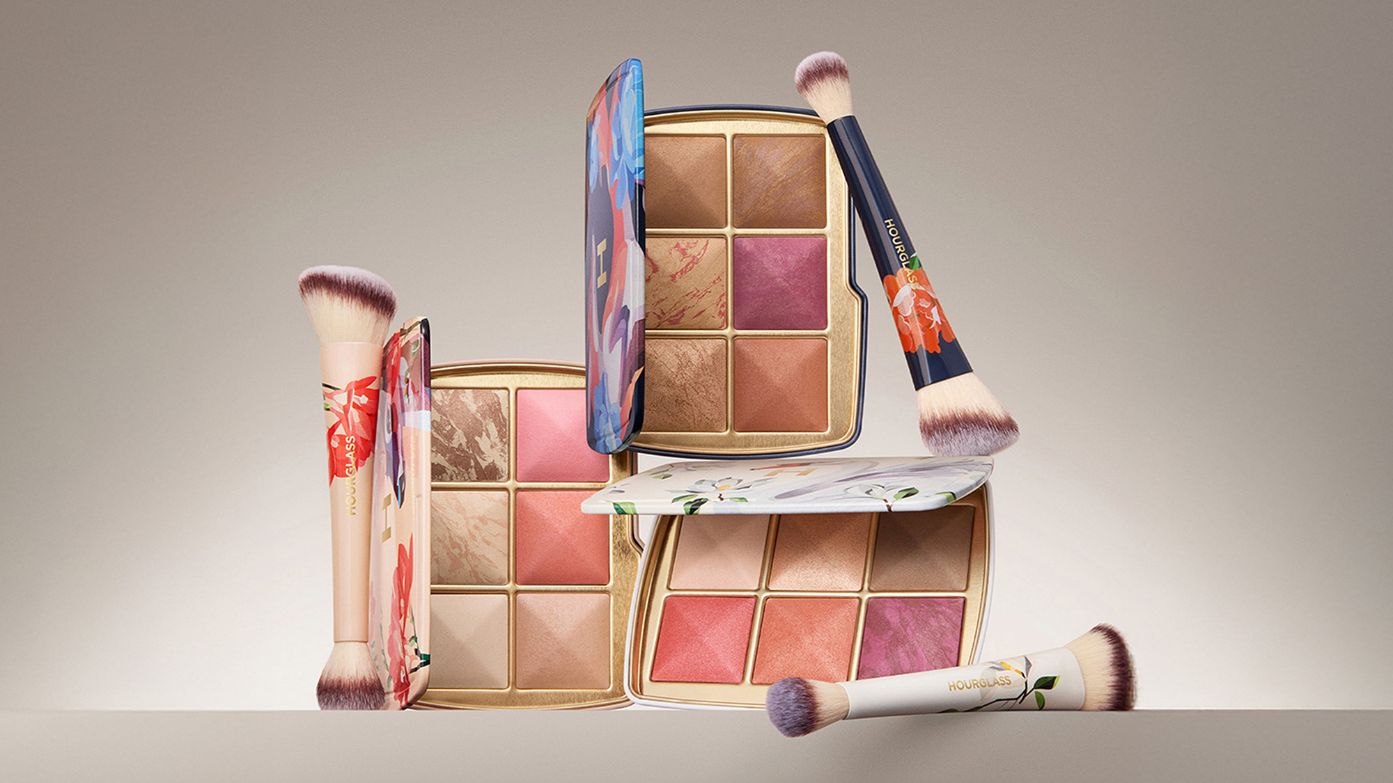 Two floral makeup palettes with various blush shades, accompanied by three matching brushes.