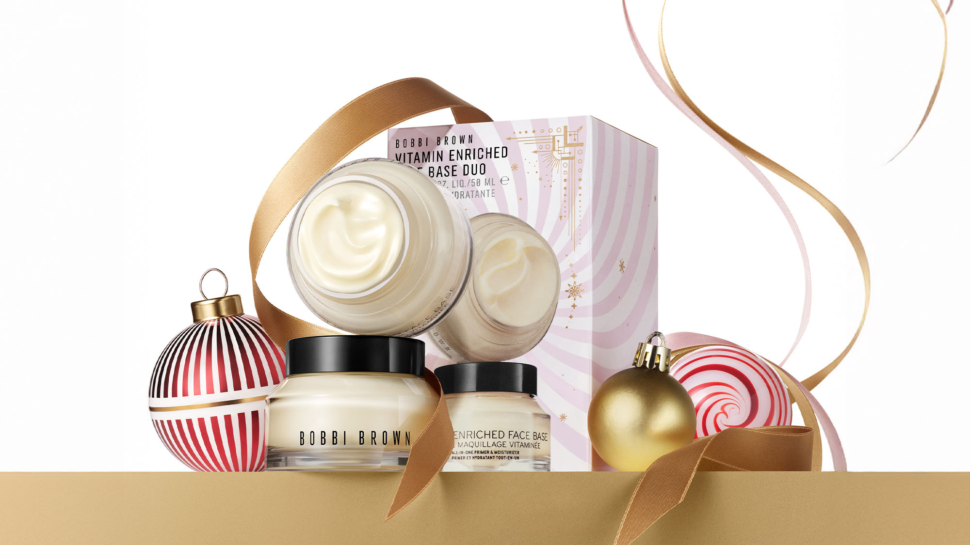 Cosmetic gift set with creams, festive packaging, and ornaments.