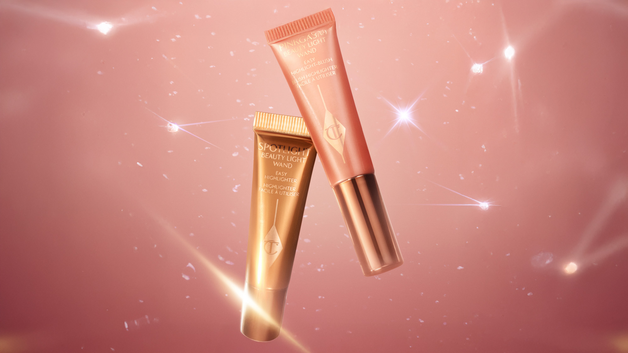 Three Charlotte Tilbury skincare products on a reflective surface: a jar and two tubes with elegant gold accents.