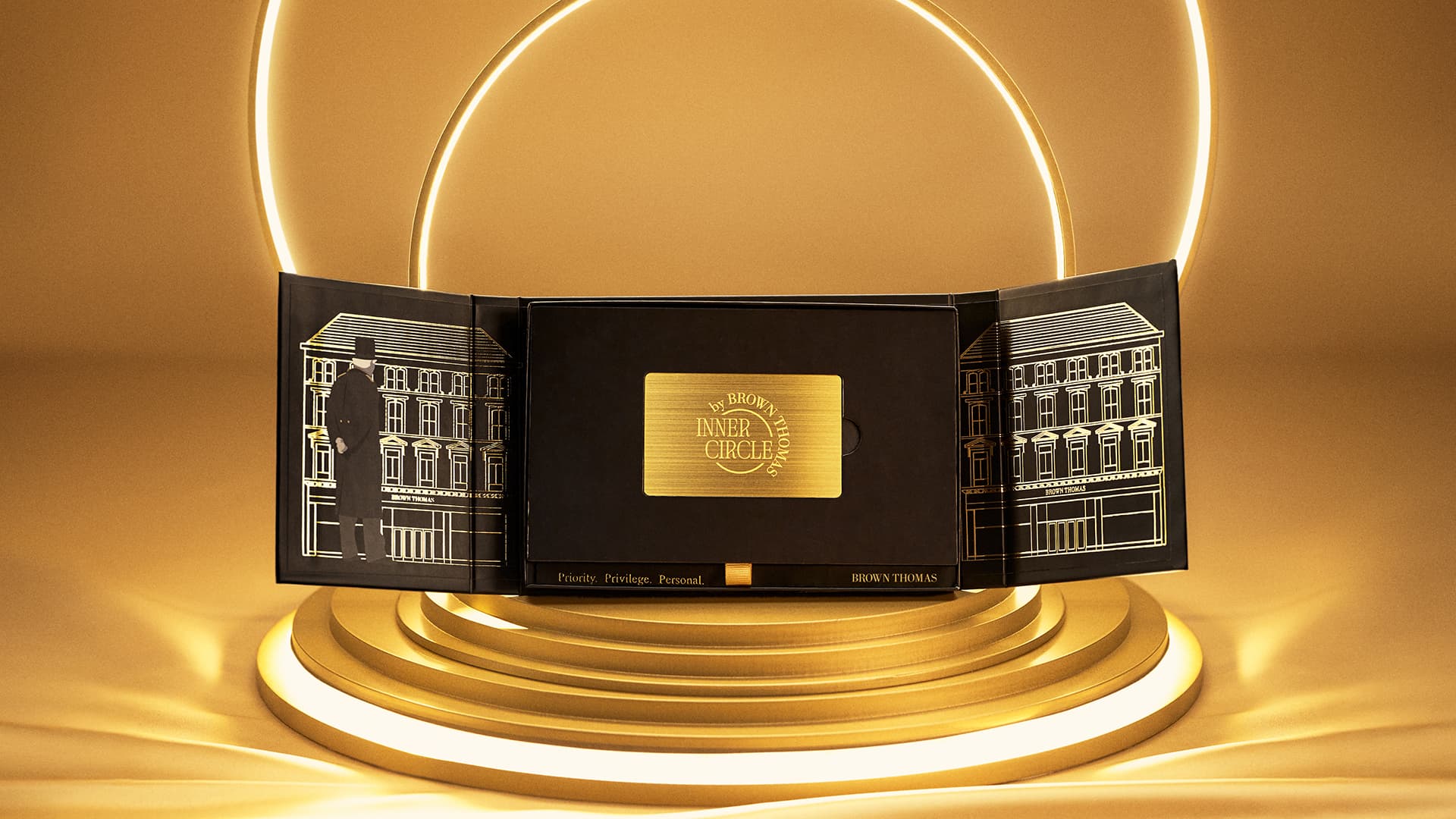 A golden Inner Circle card inside of a black box on a golden surface with bright lights