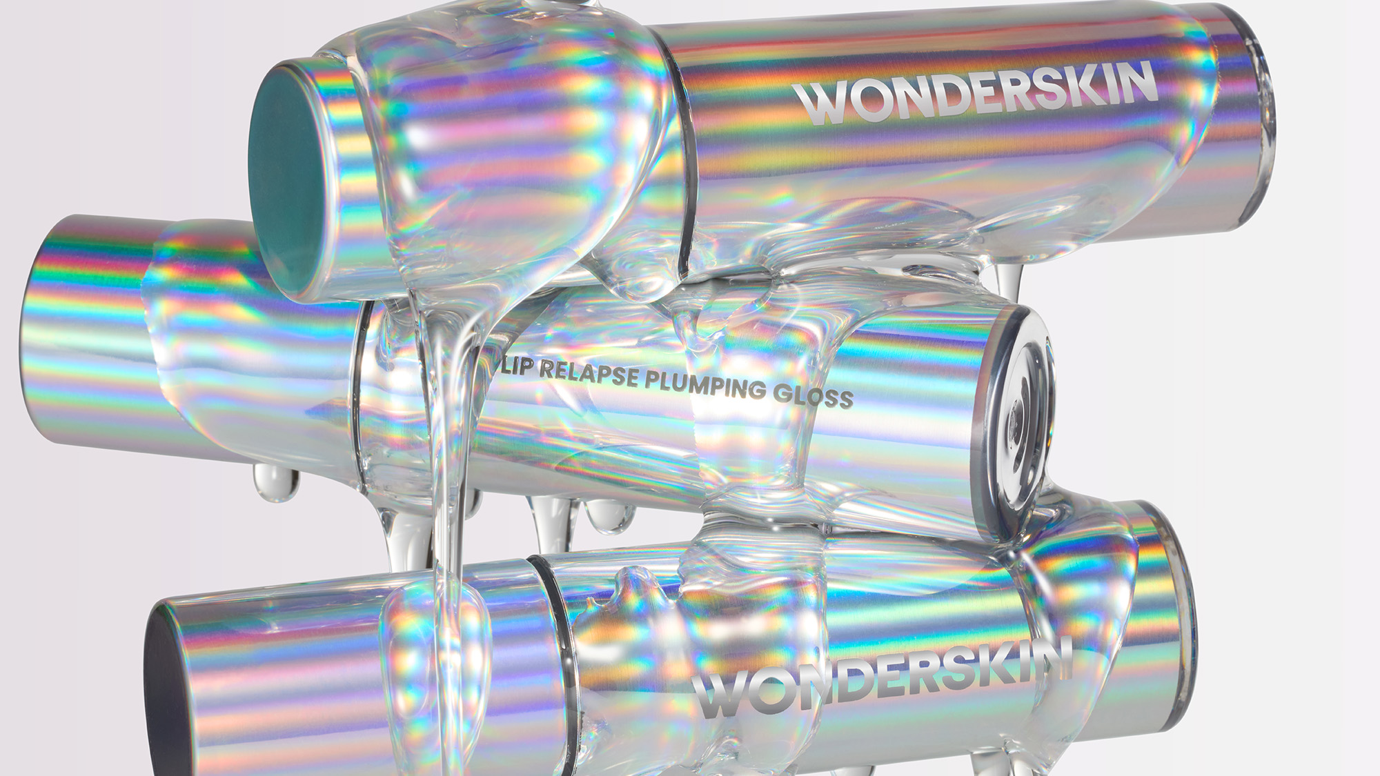 Holographic lip gloss tubes with 'Wonderskin' branding, stacked with a glossy sheen.