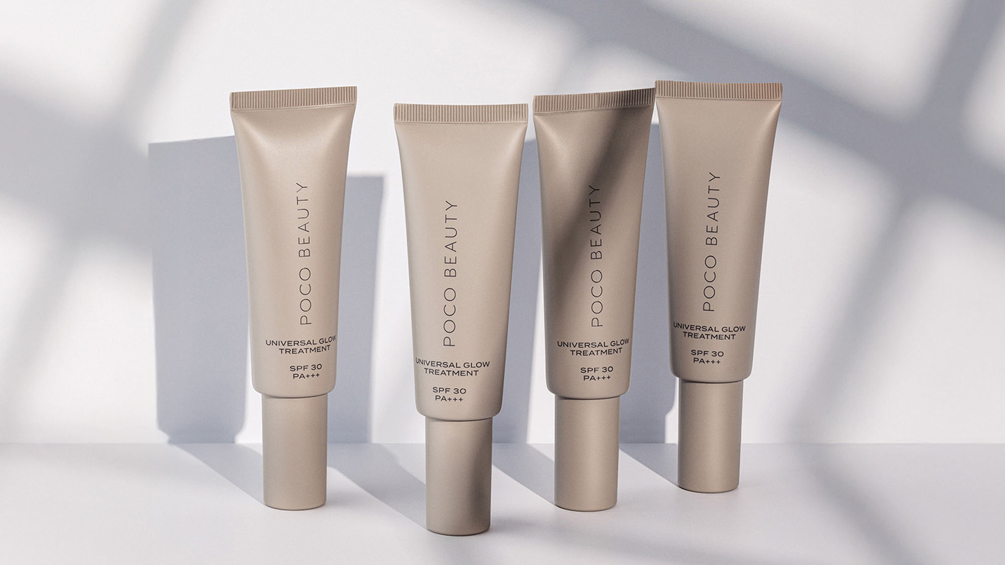Four tubes of Poco Beauty Universal Glow Treatment SPF 30, arranged in a row.