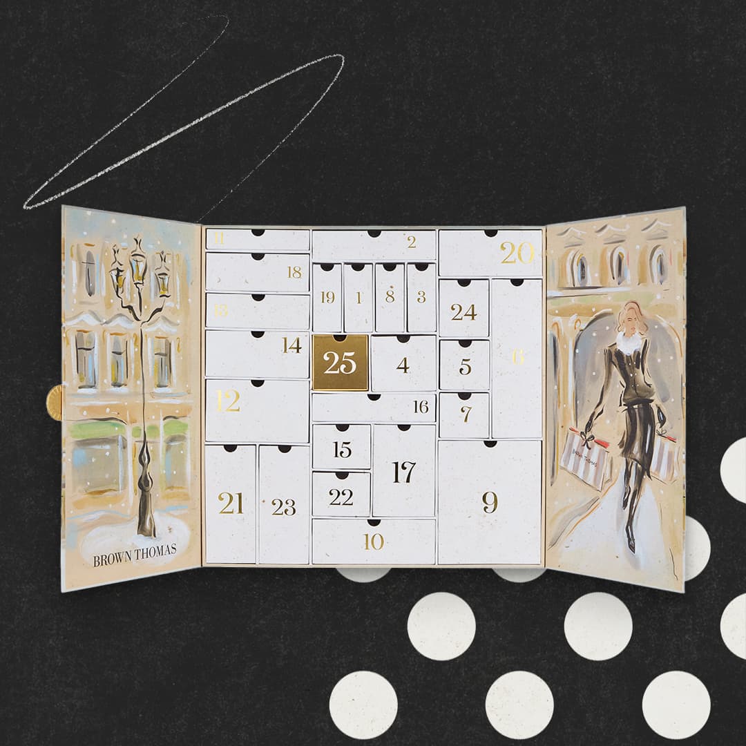 An open advent calendar with numbered doors, featuring a street scene and a woman carrying shopping bags.