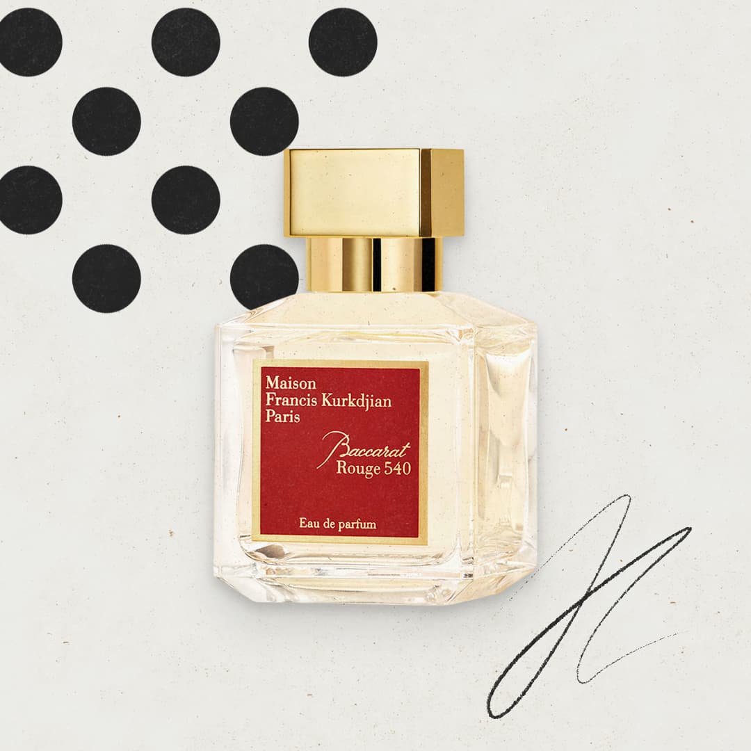 Perfume bottle of Maison Francis Kurkdjian Baccarat Rouge 540 with gold cap, on a plain background with black dots and abstract lines.