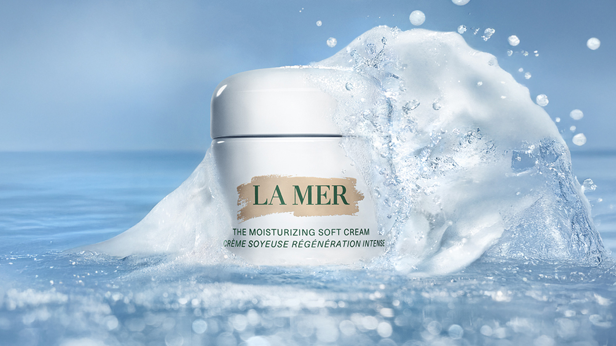 A jar of La Mer moisturizing cream surrounded by splashing water.