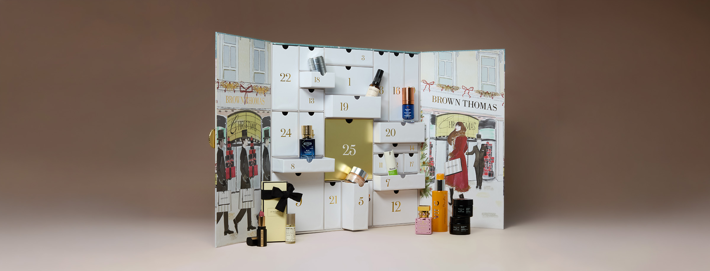An opened advent calendar featuring various beauty products. The calendar has compartments numbered 1 to 25, with a larger central door. Several cosmetic items, such as bottles and boxes, are displayed around the calendar. Illustrations of people shopping accentuate the festive theme..