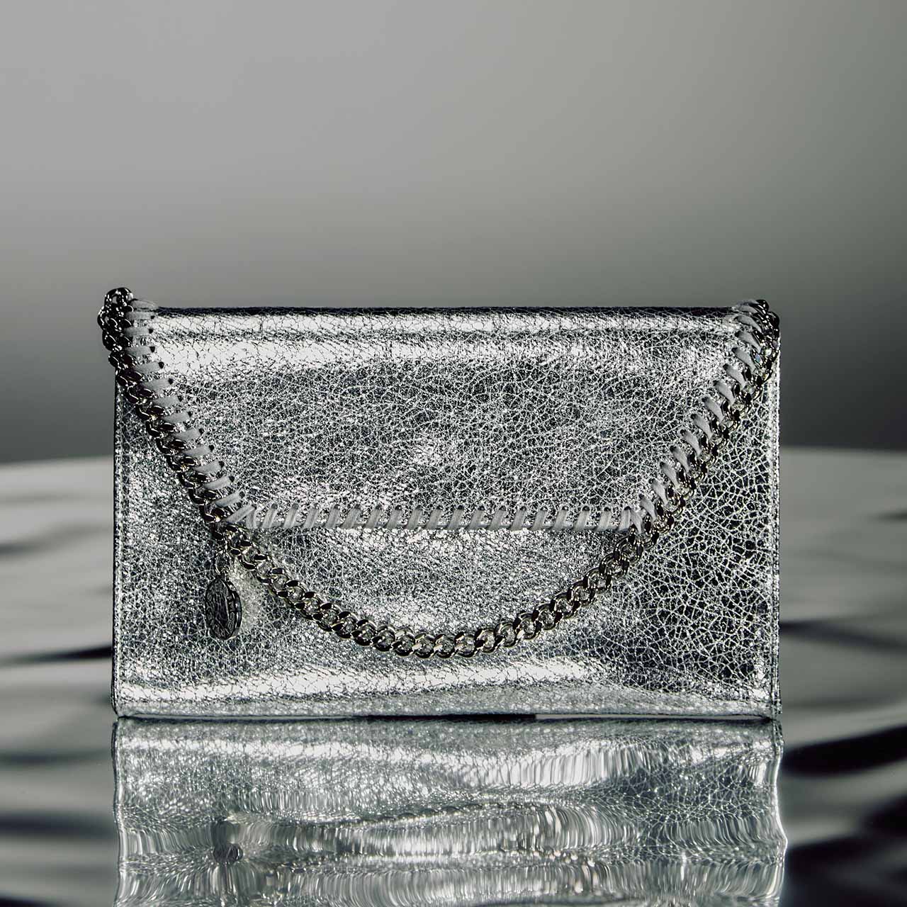 Silver metallic clutch bag with chain handle and whipstitched detail