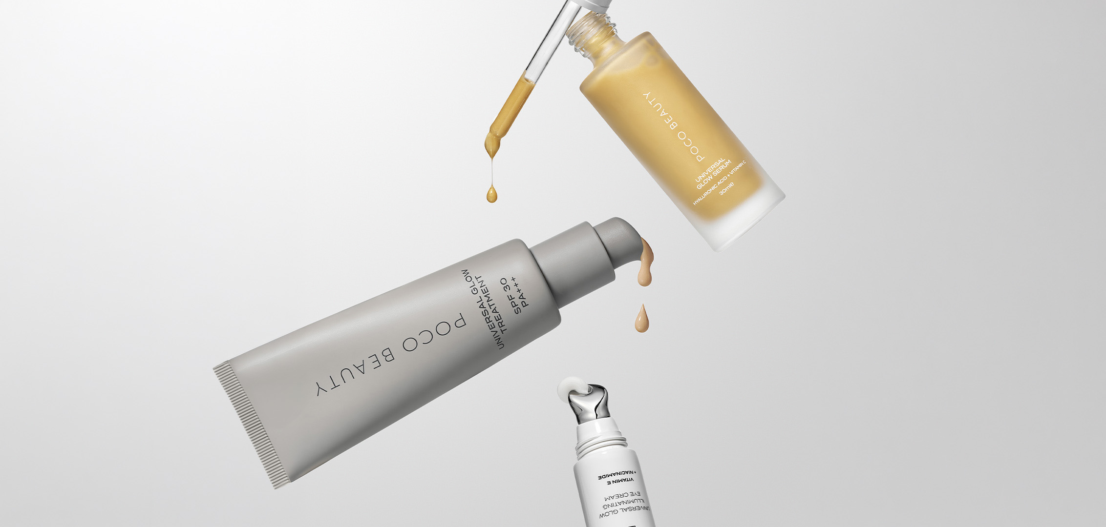 Three beauty products displaying serums and treatments with droplets, showcasing luxury skincare collection