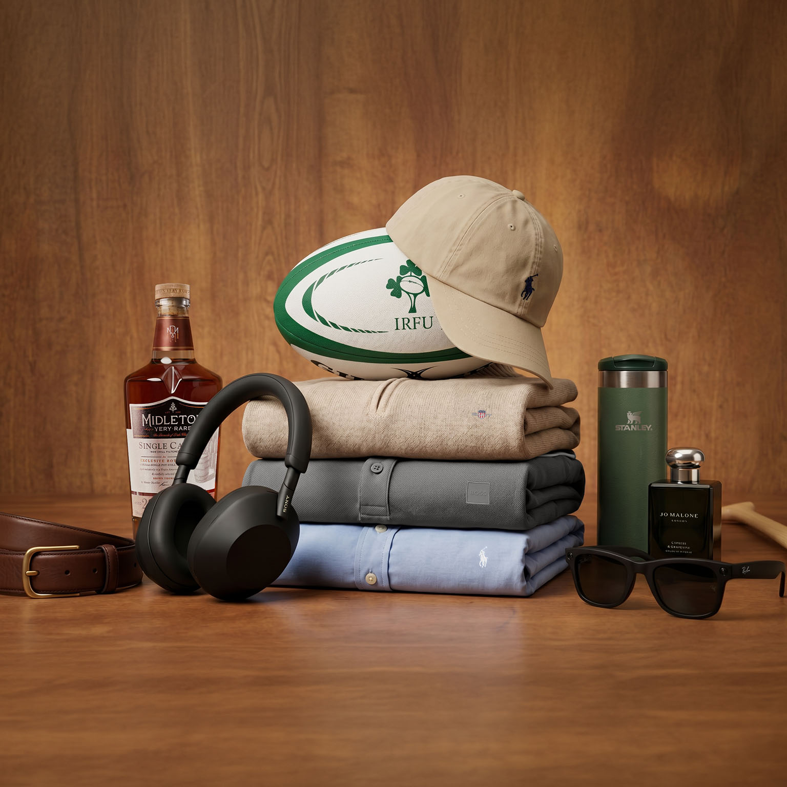 Father's Day gift collection including whisky, headphones, clothing, rugby ball, sunglasses and cologne