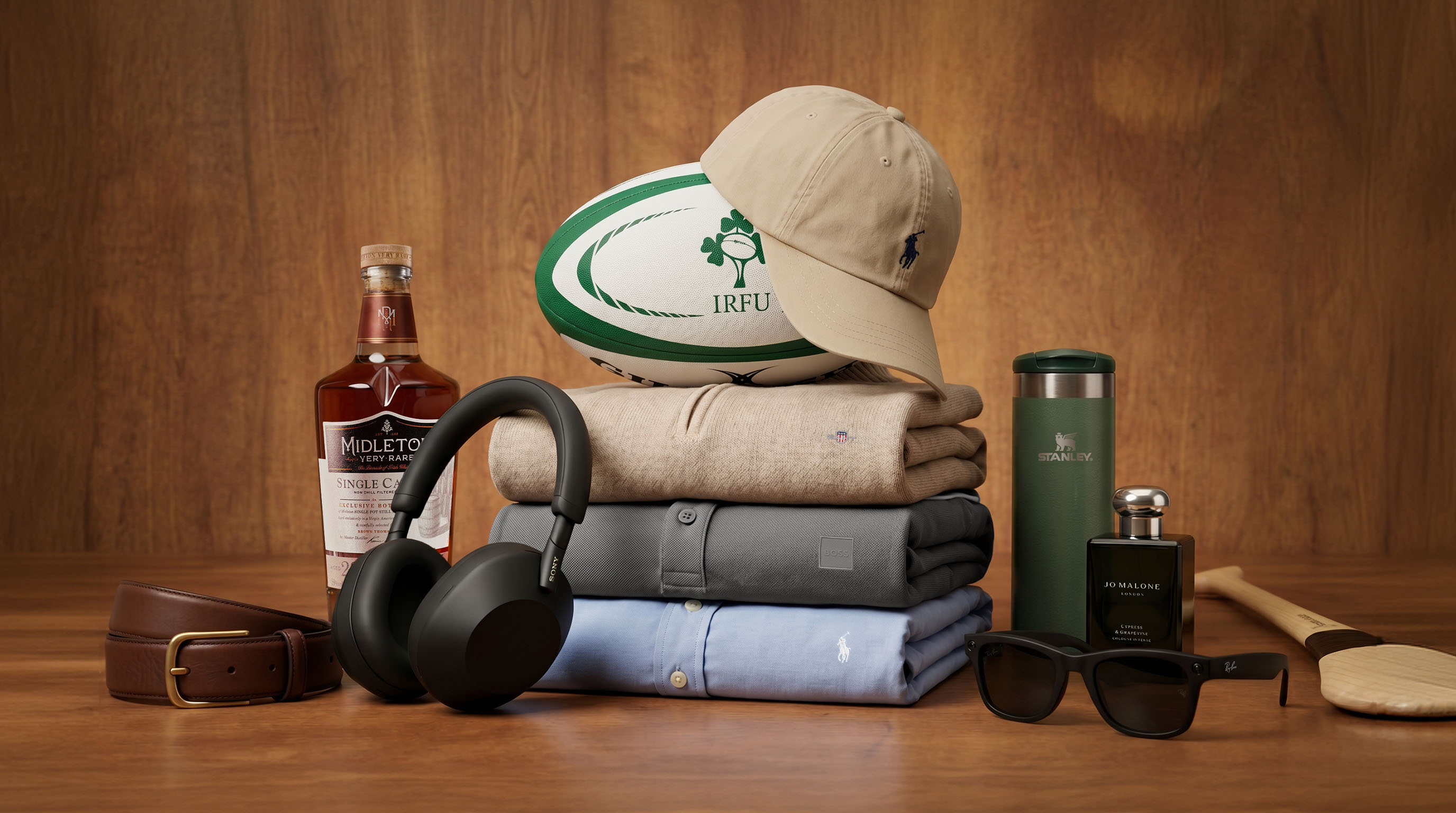 Father's Day gift collection including whisky, headphones, clothing, rugby ball, sunglasses and cologne