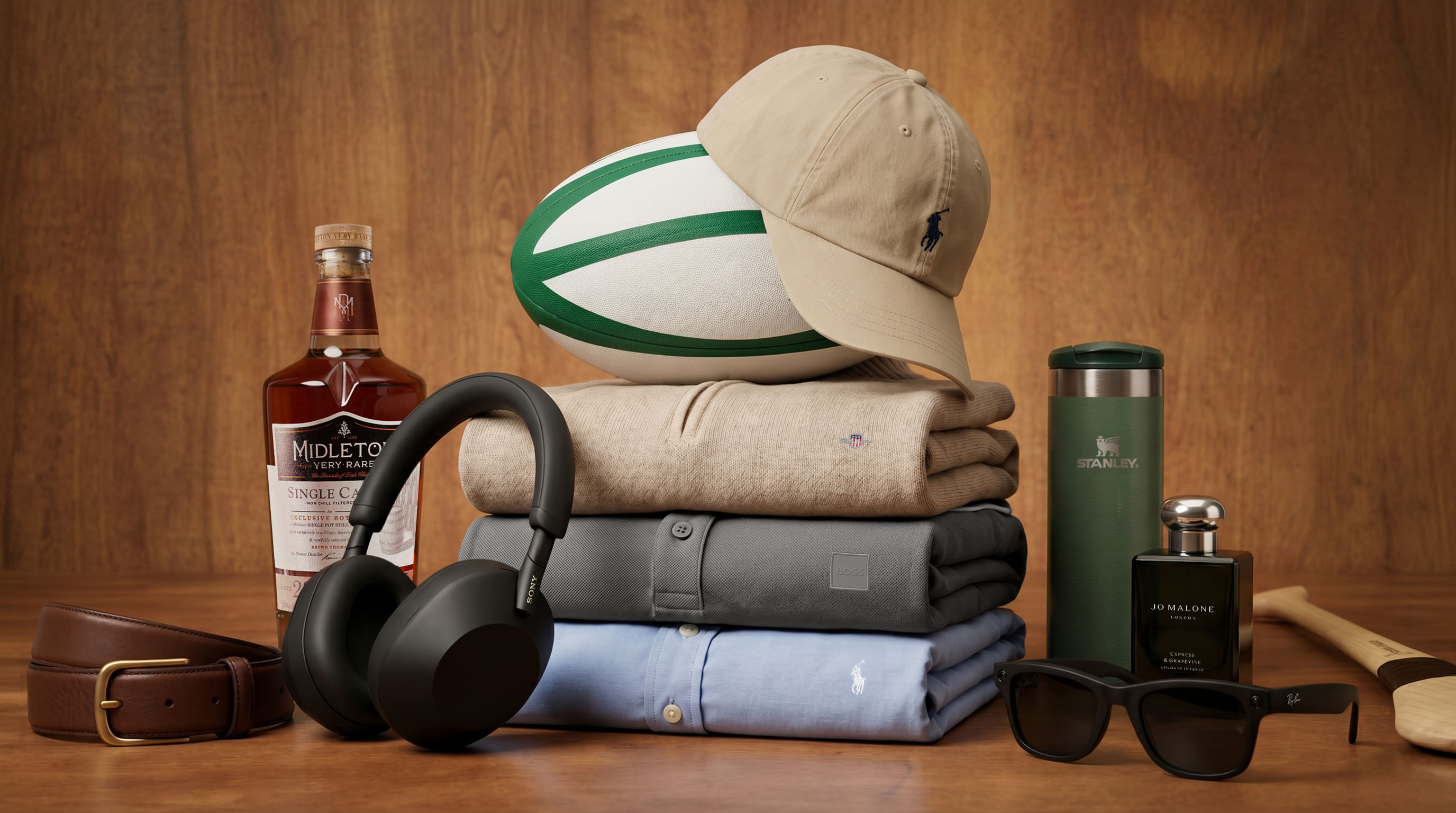 Father's Day gift collection including whisky, headphones, clothing, rugby ball, sunglasses and cologne