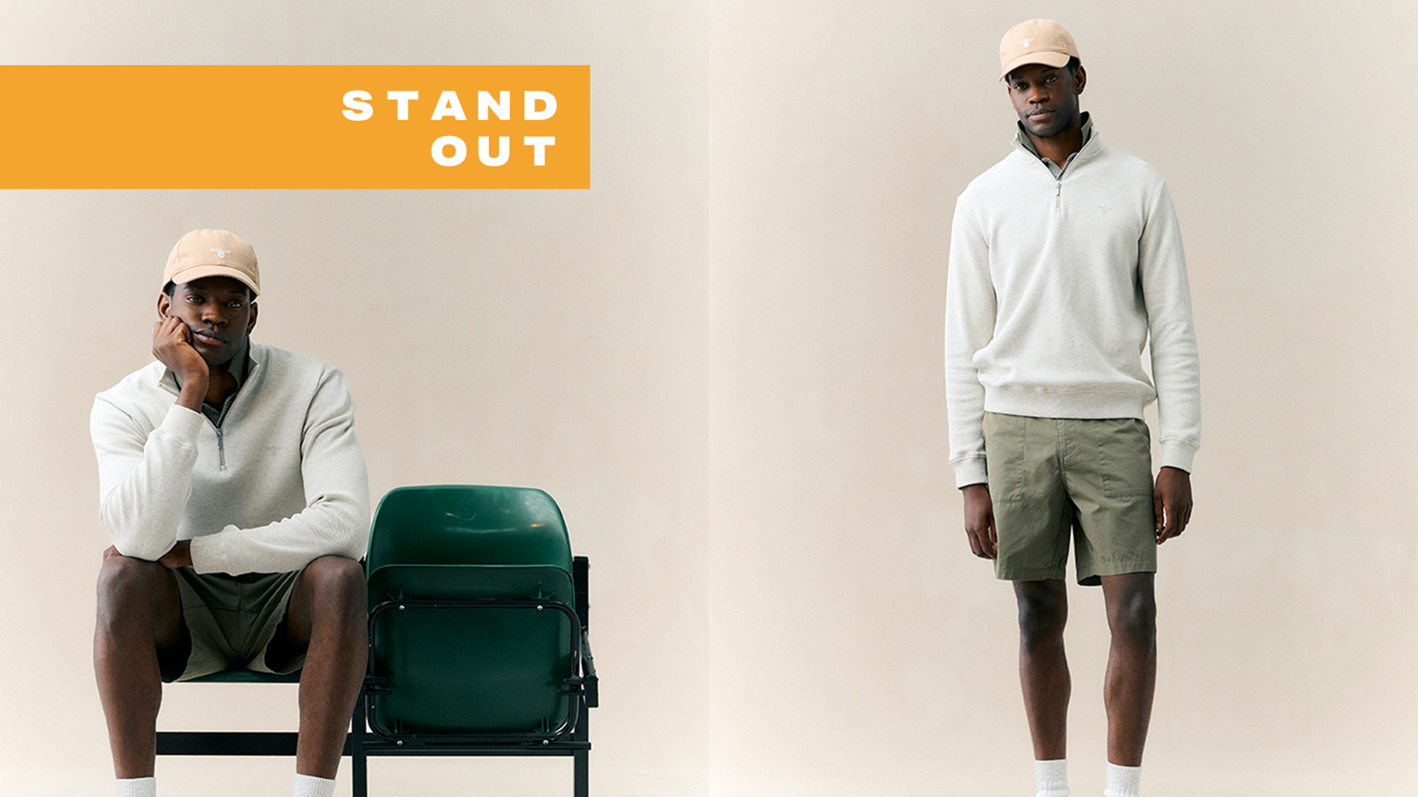 Two male models wearing neutral casual wear: one in cream quarter-zip sweatshirt and dark shorts, one in cream sweatshirt and sage shorts with baseball caps
