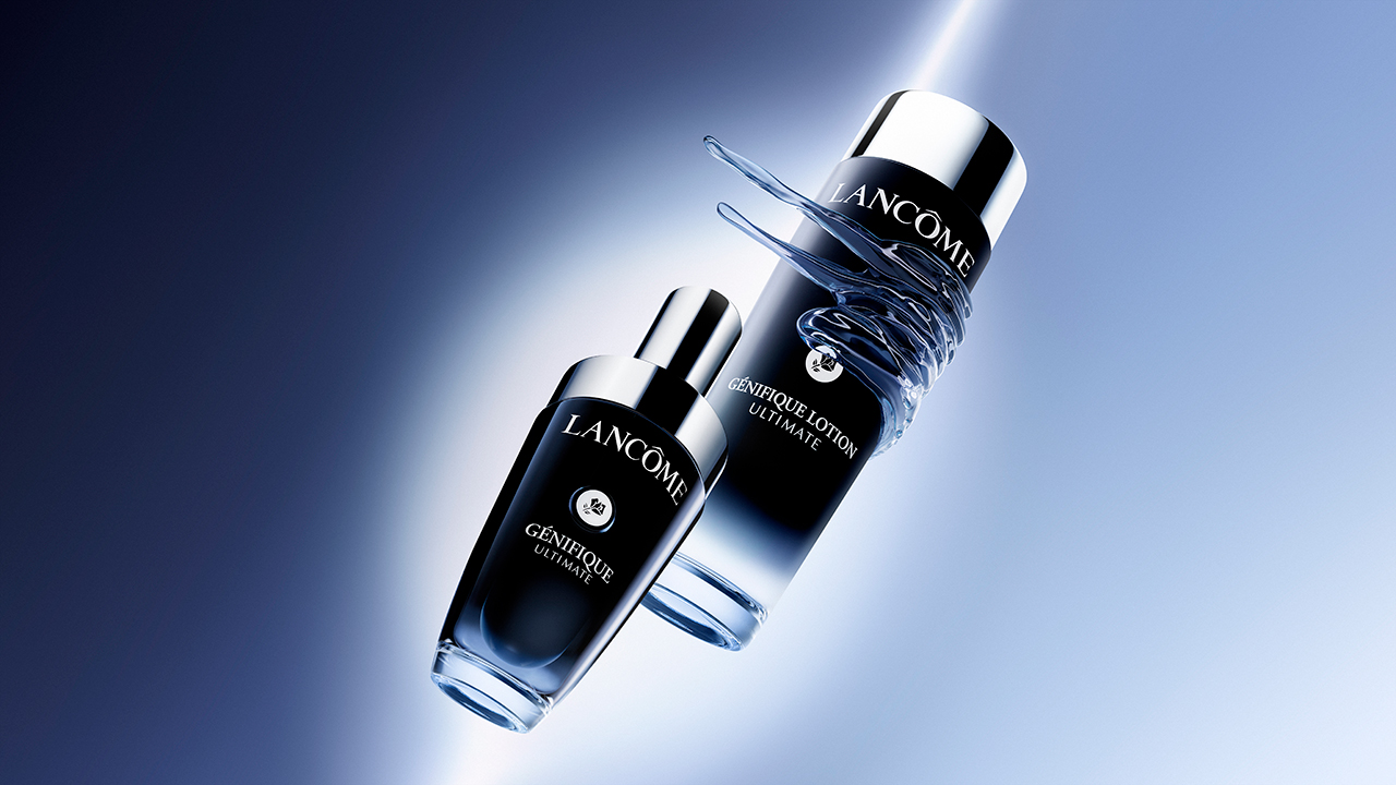 Two Lancôme skincare bottles against a gradient blue background.