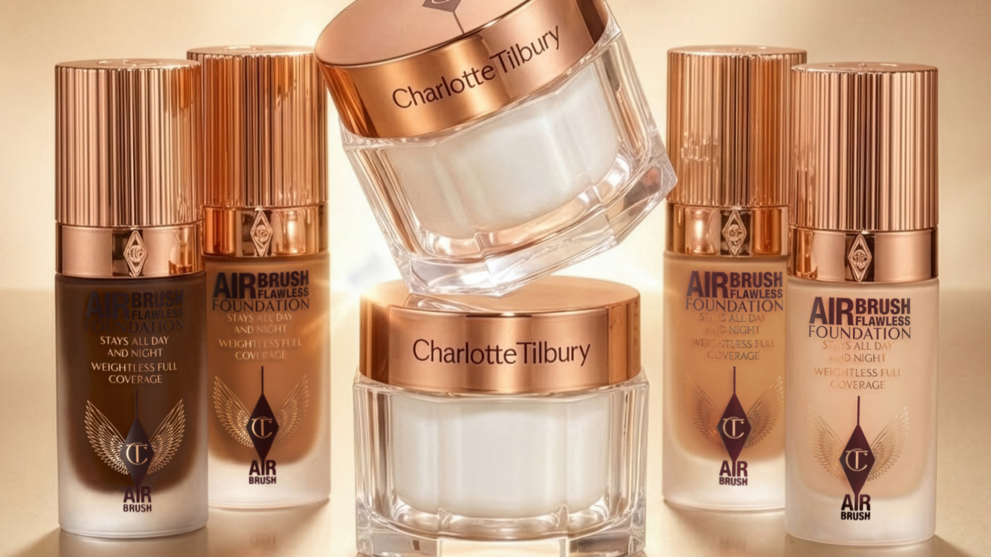Charlotte Tilbury beauty products, including foundation and creams, in elegant rose gold packaging.
