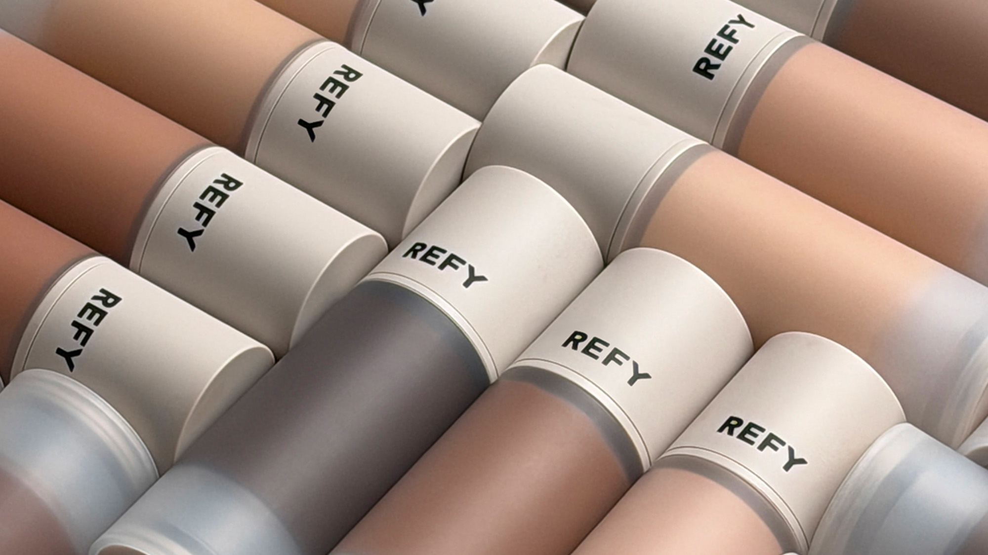 REFY Skin Base foundation bottles in multiple shades arranged diagonally showing range of complexion colours