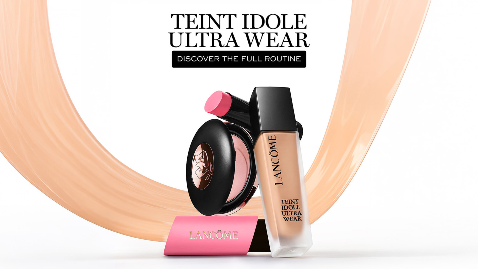 Lancôme Teint Idole Ultra Wear foundation bottle, pink blush compact and lipstick displayed against peach brushstroke background