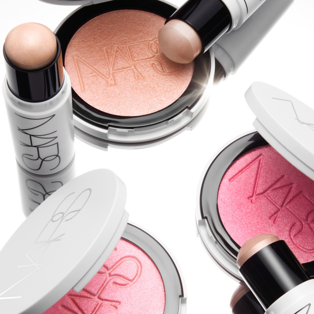 NARS Light Reflecting highlighting stick with matching powder highlighters in peachy and pink tones on white background