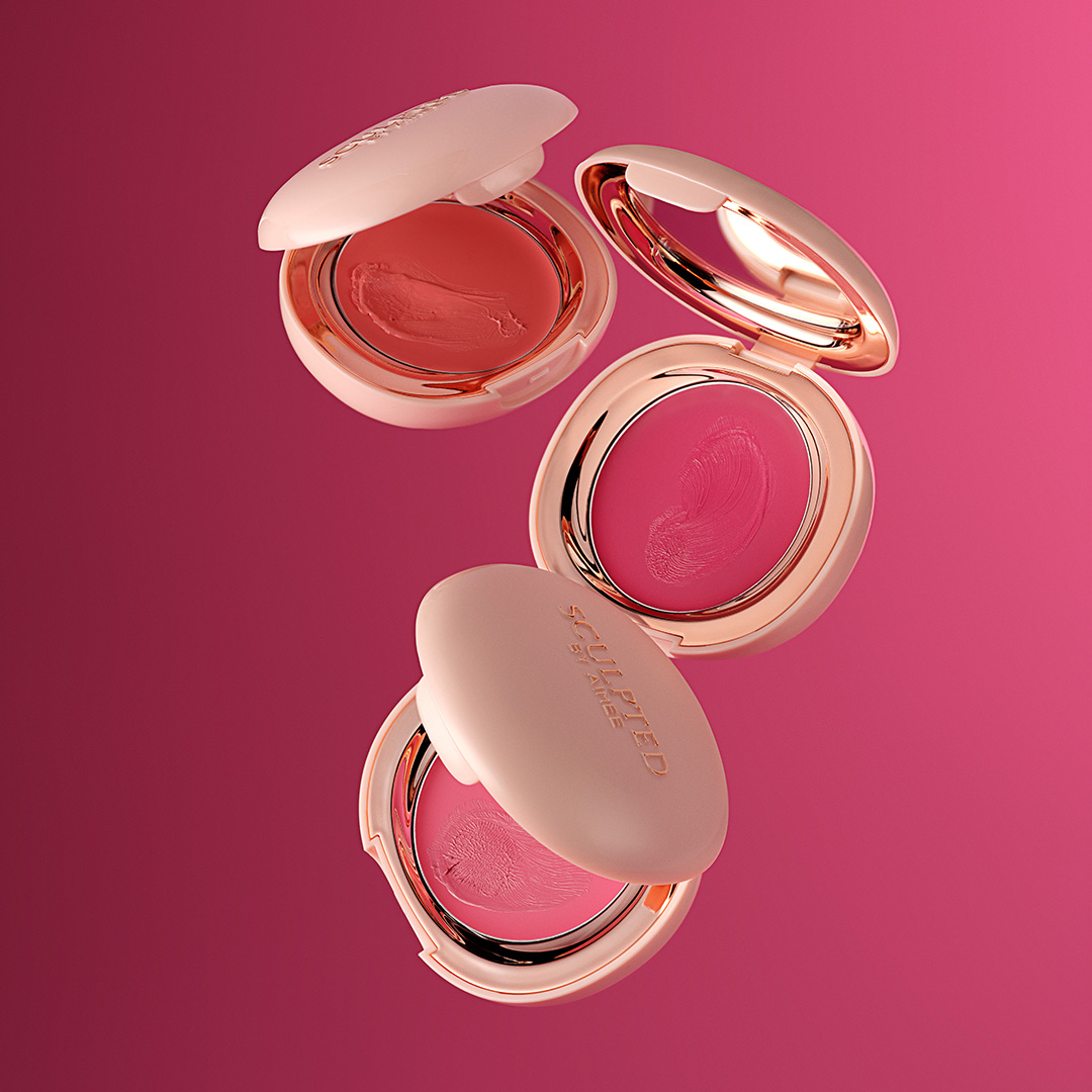 Creme Luxe collection cream eyeshadows and blush compacts in coral and pink shades with pearl finishes on pink background