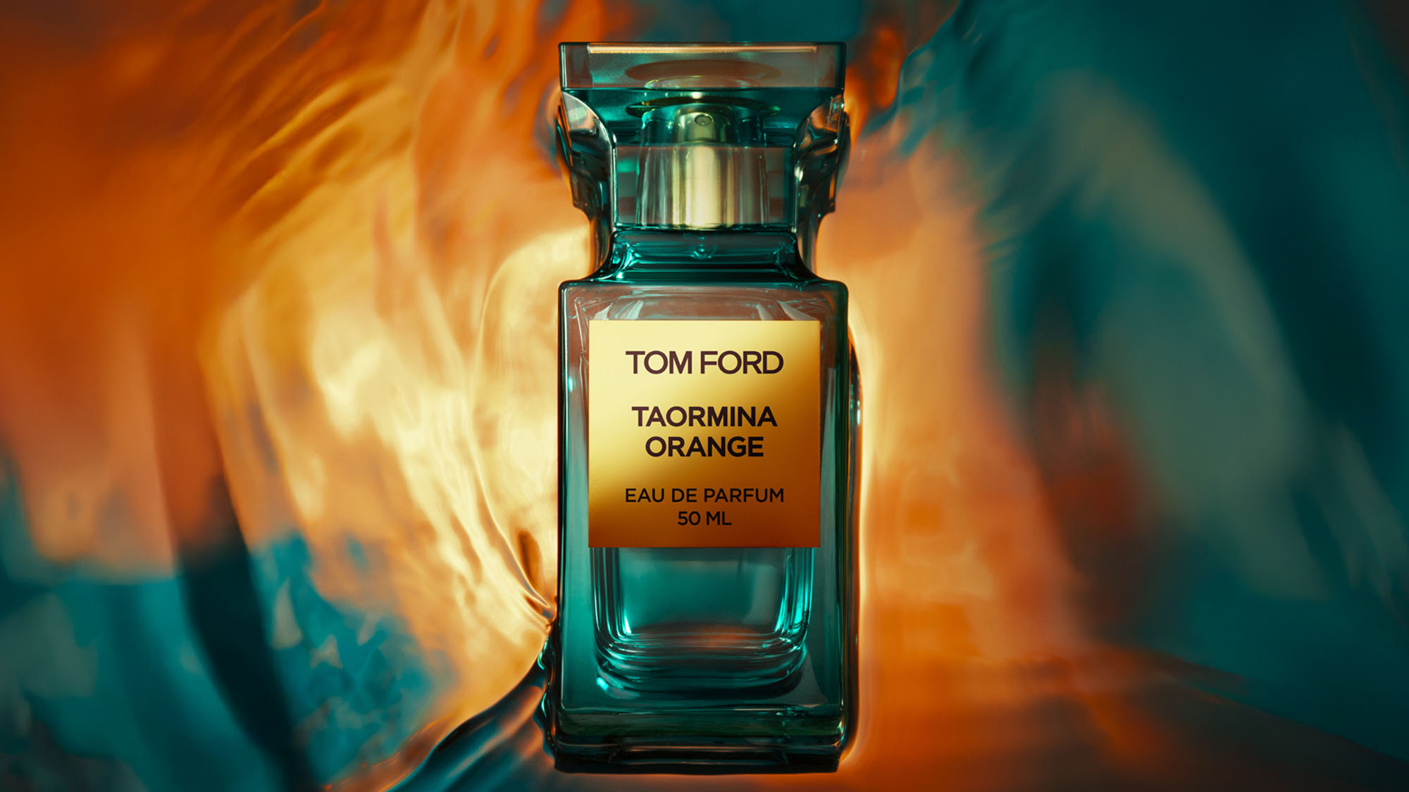 A bottle of Tom Ford Taormina Orange Eau de Parfum is centered against a vibrant, abstract orange and teal background.