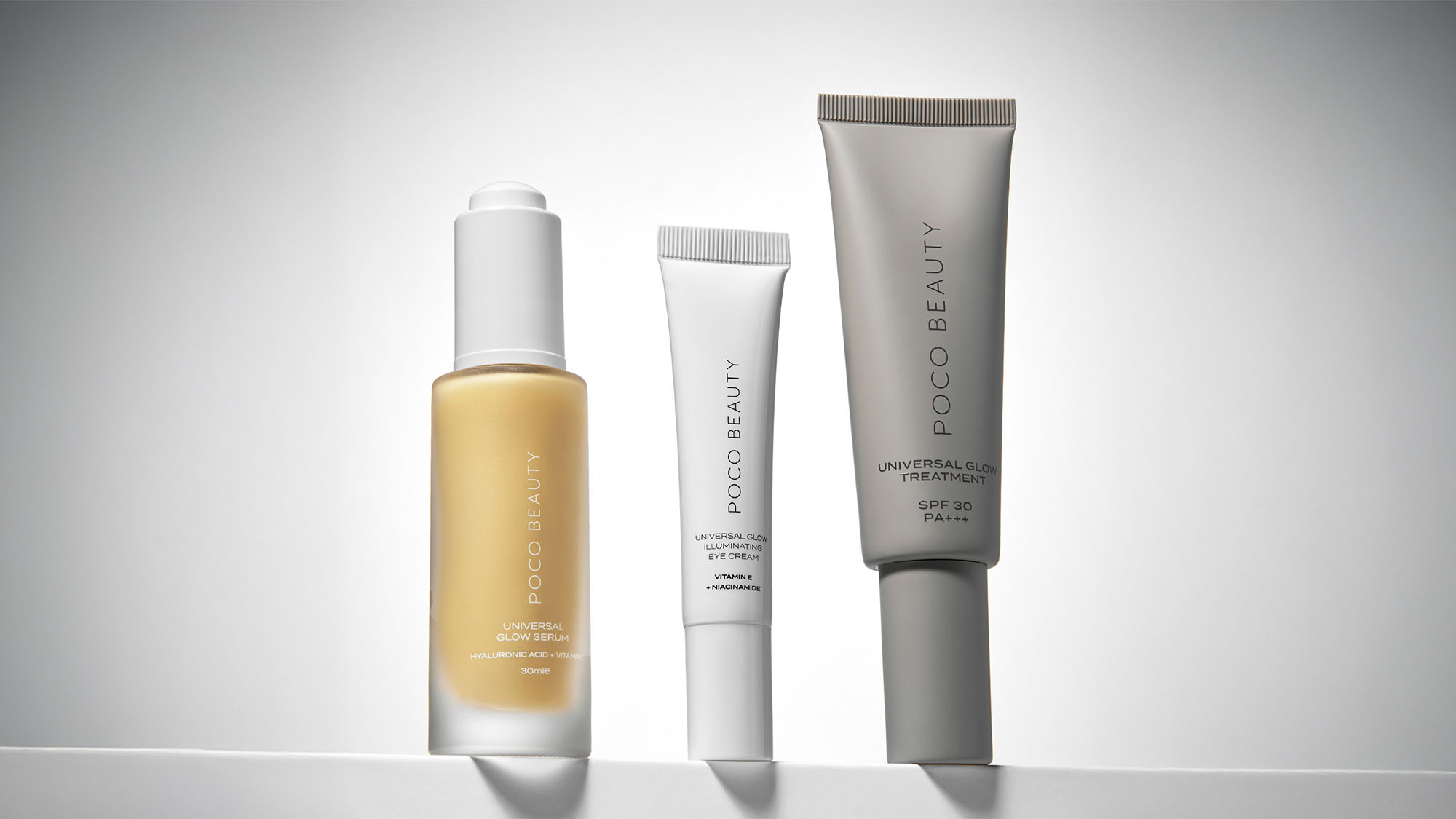 Three POCO Beauty skincare products in sleek, minimalist packaging against a neutral background.