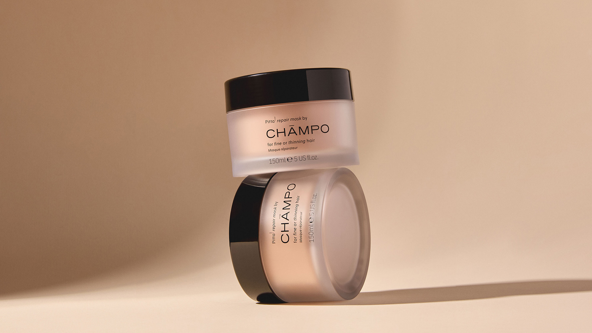 Champo hair care products including shampoo, conditioner and styling treatments in beige and black packaging