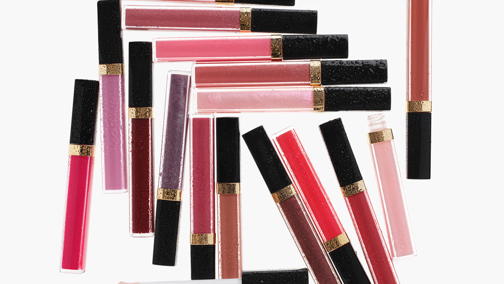 Collection of CHANEL Coco Rouge lipsticks and lip glosses in assorted shades from pink to burgundy with gold trim