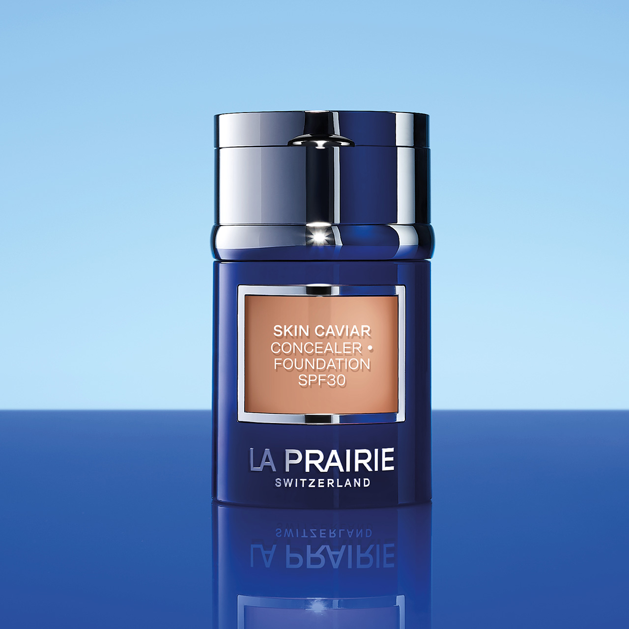 La Prairie Skin Caviar Concealer Foundation SPF30 in dark blue bottle against blue gradient background