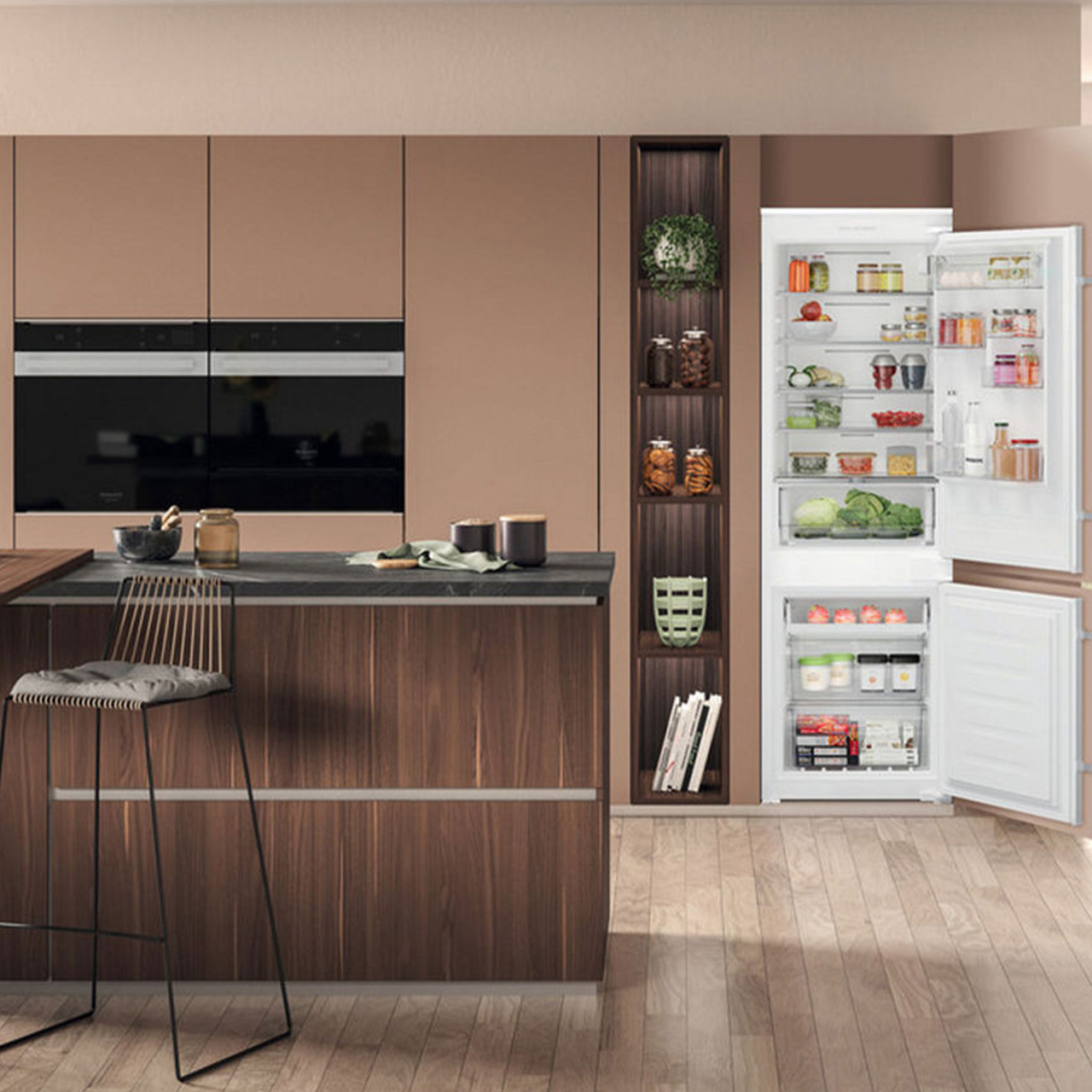 Modern kitchen with walnut cabinetry, black built-in appliances, and an open white refrigerator stocked with fresh food