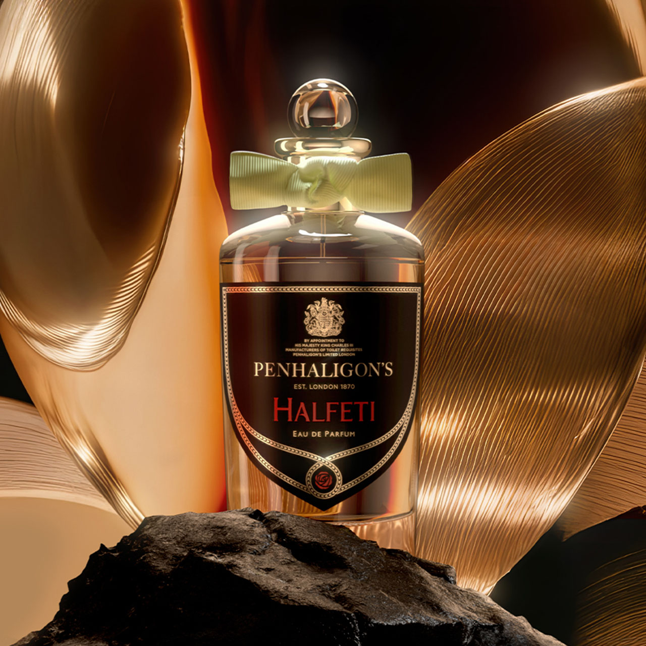 Penhaligon's Halfeti eau de parfum bottle surrounded by golden curved sculptural elements and dark stone