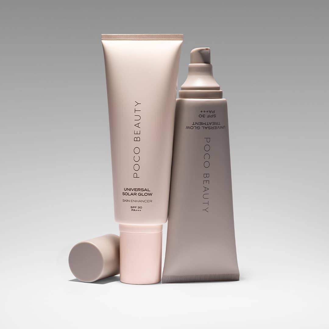 Two tubes of Poco Beauty products, labelled as Universal Solar Glow Shine Enhancer and Colour Dew Enhancer, both with SPF 30. One tube is upright with its cap on the side, while the other is tilted with its cap removed. Both have a minimalist design and a soft colour palette.
