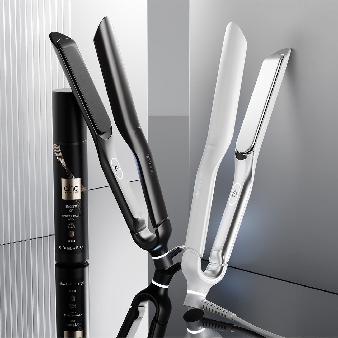 Ghd hair styling tools including straighteners and interactive styler in black and white finishes with heat styling spray