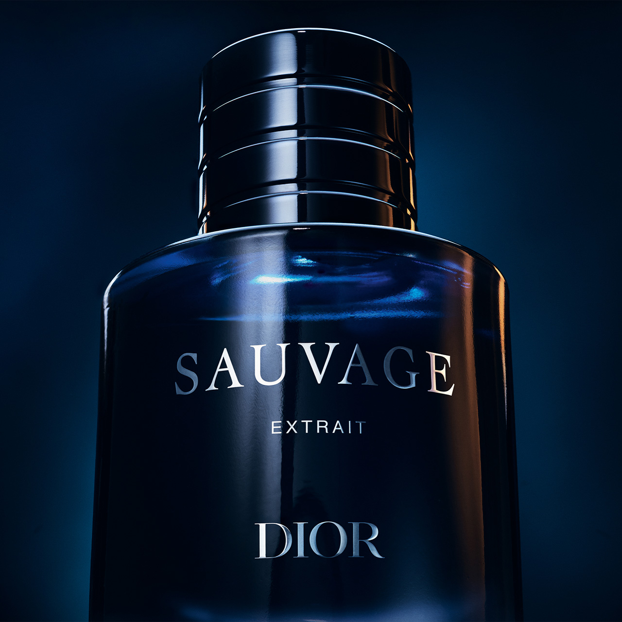 A dark blue bottle labeled 'SAUVAGE EXTRAIT DIOR' against a moody background.