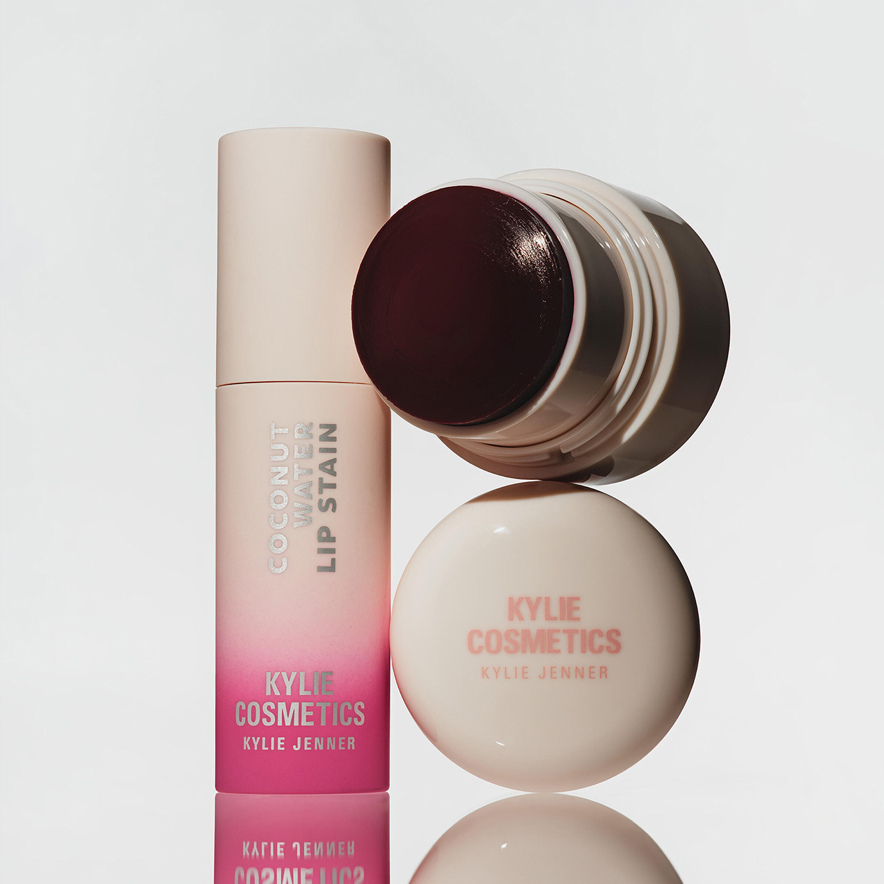 Kylie Cosmetics lip products including pink gradient lip stain and nude lip pot with dark burgundy lid