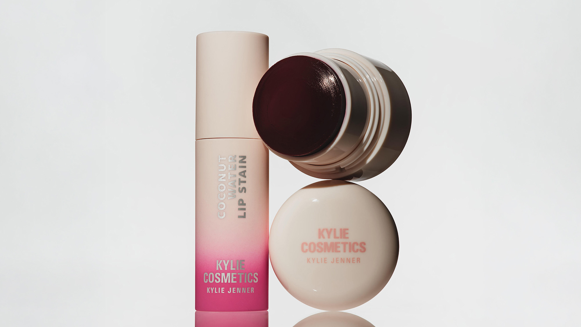 Kylie Cosmetics lip products including pink gradient lip stain and nude lip pot with dark burgundy lid