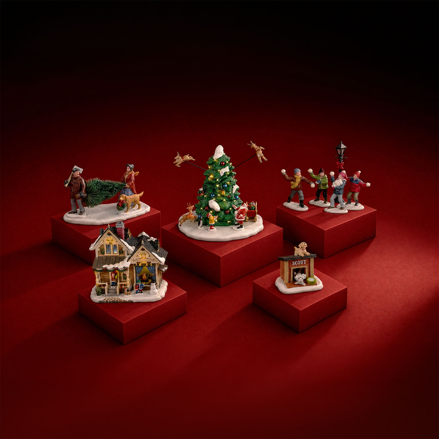 Miniature Christmas village scenes including decorated house, decorated tree, carollers and figures with accessories