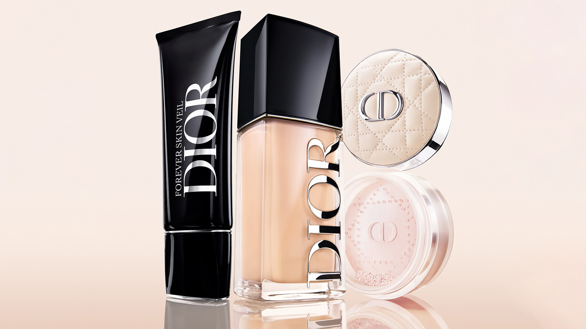 Dior Forever makeup collection including foundation, powder compact, skincare serum and highlighter arranged on neutral background