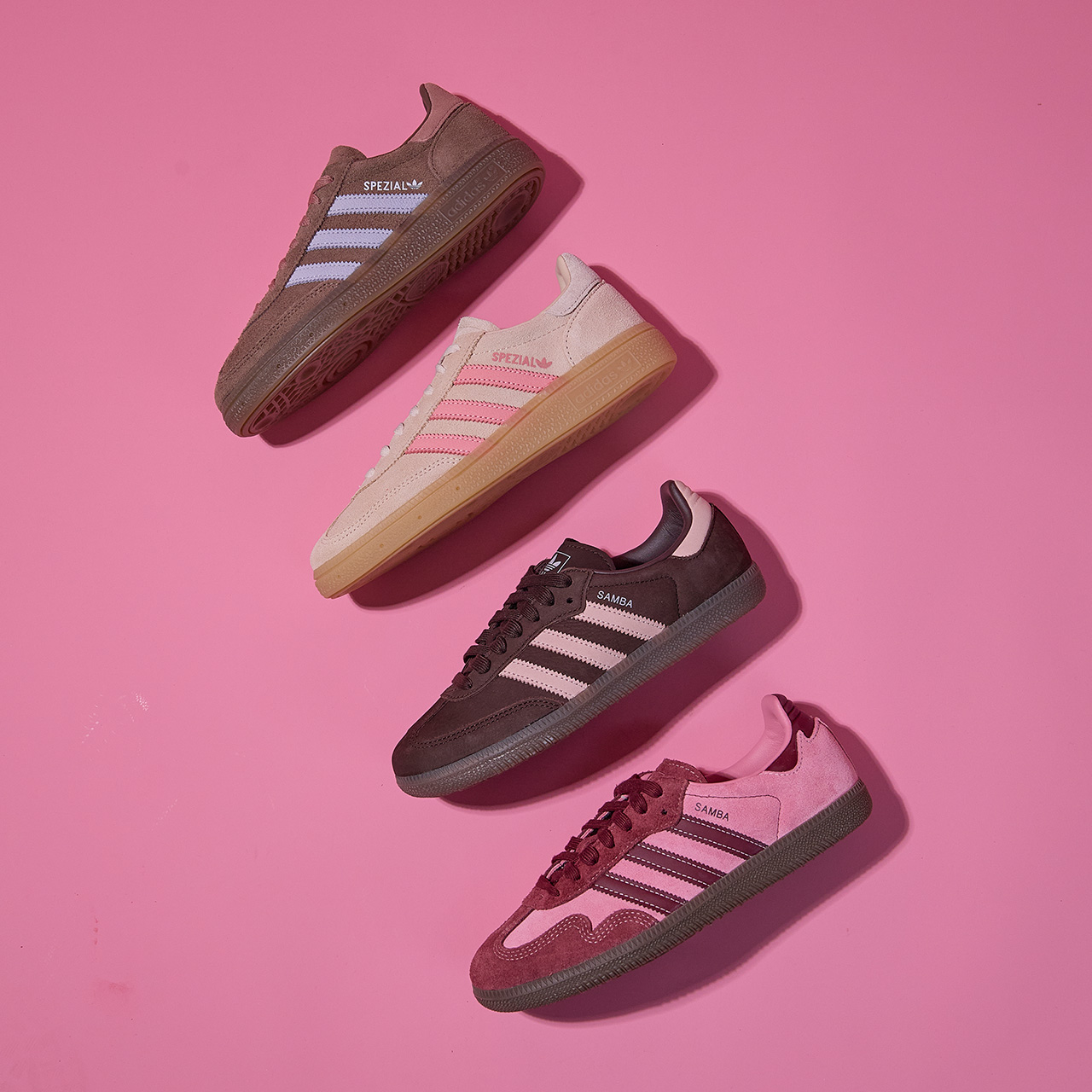 Four Adidas trainers in brown, cream, and pink colourways arranged on pink background