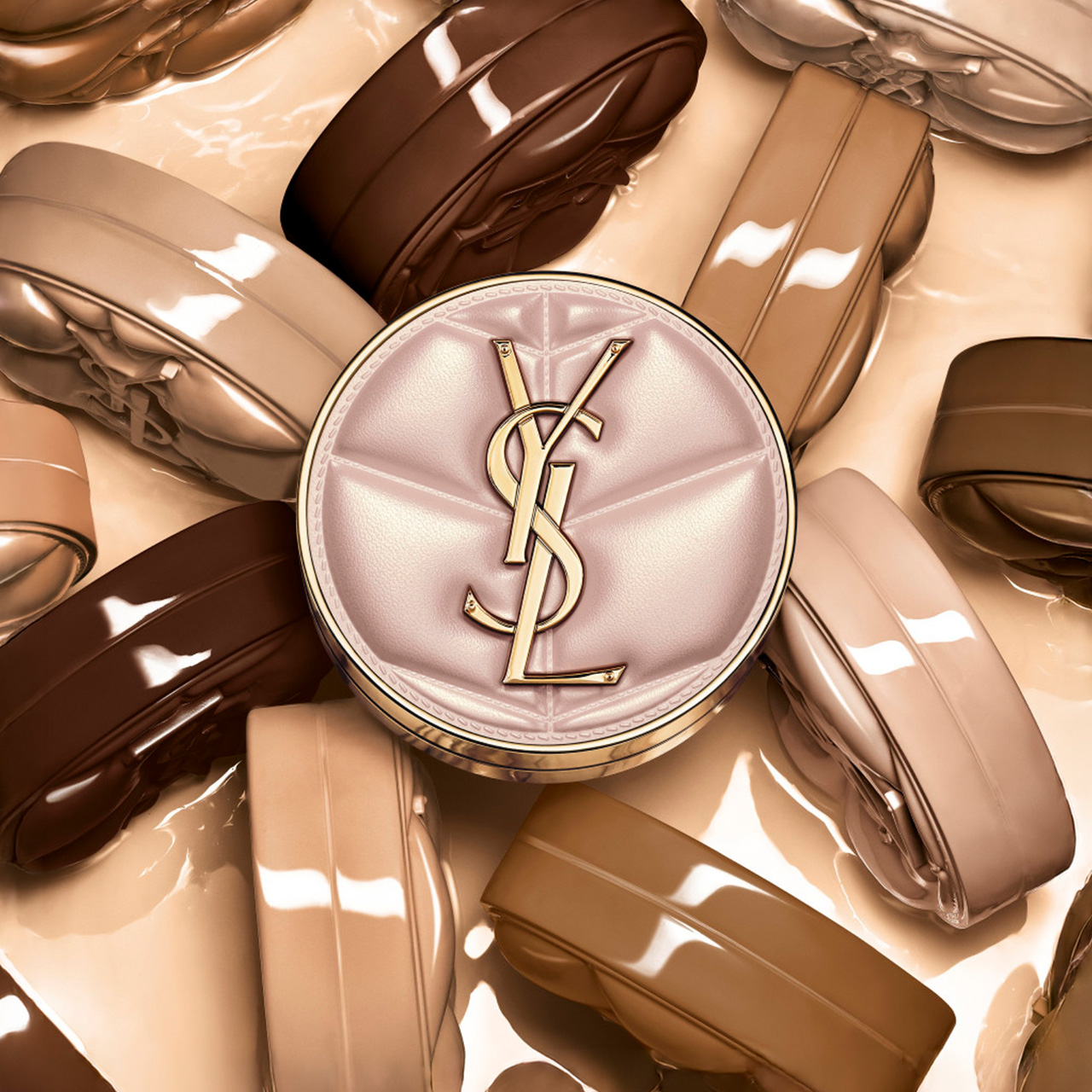 Pink quilted cushion foundation with gold YSL monogram surrounded by nude and brown makeup swatches