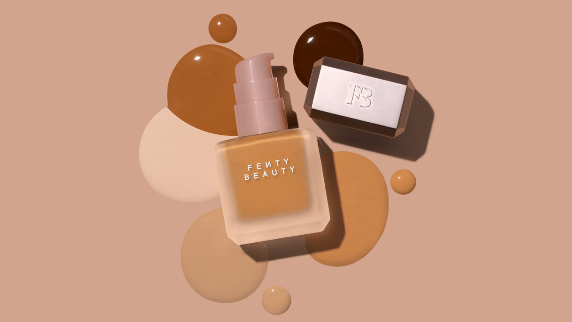Fenty Beauty foundation bottle with pink pump surrounded by abstract spheres in warm beige and brown tones
