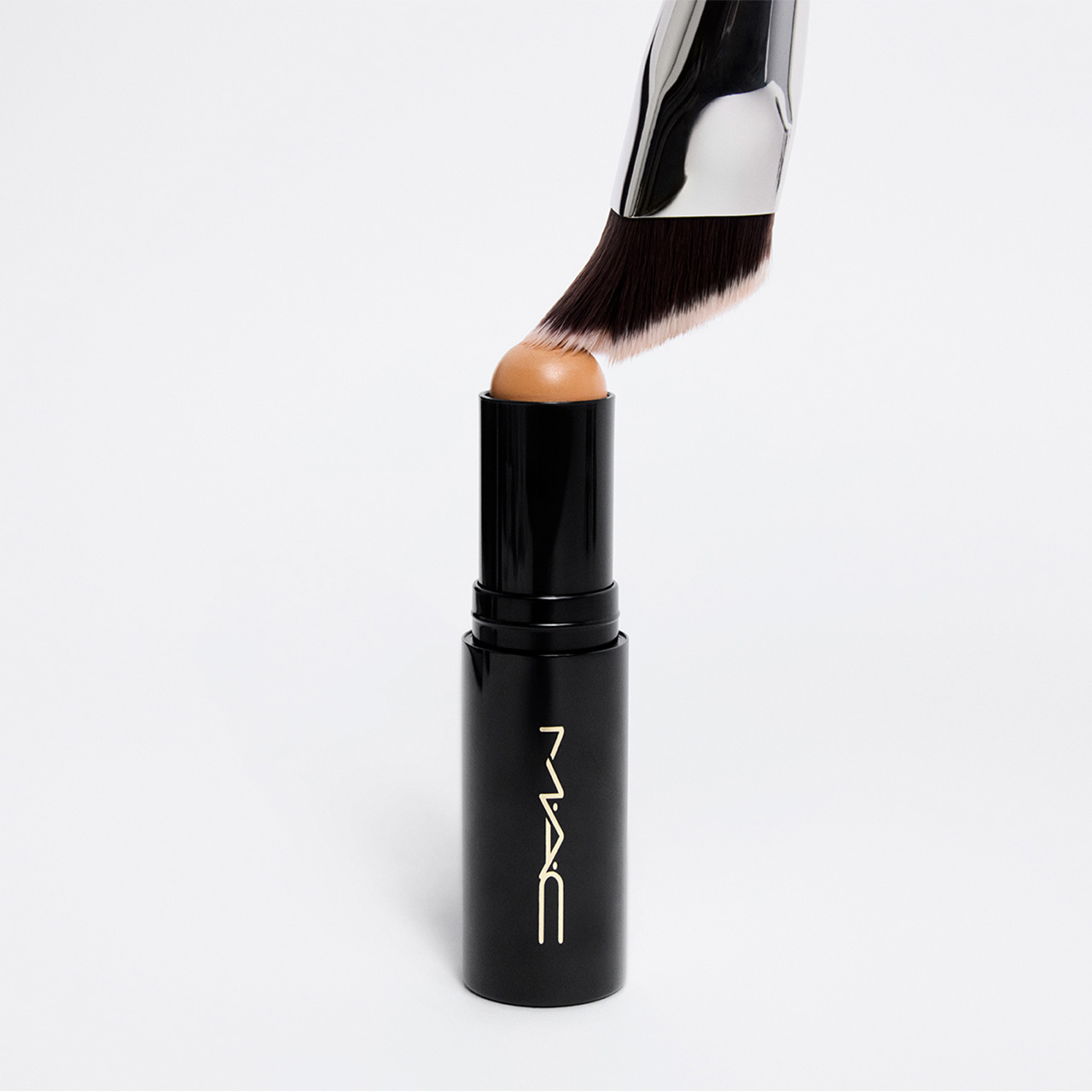M.A.C Studio Radiance Skin Tint Stick in warm tone with makeup brush applicator