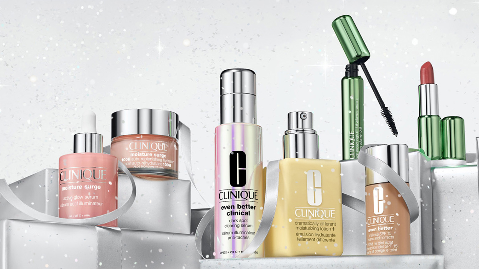 Clinique skincare and makeup range including serums, moisturisers, lipstick and mascara on white surface