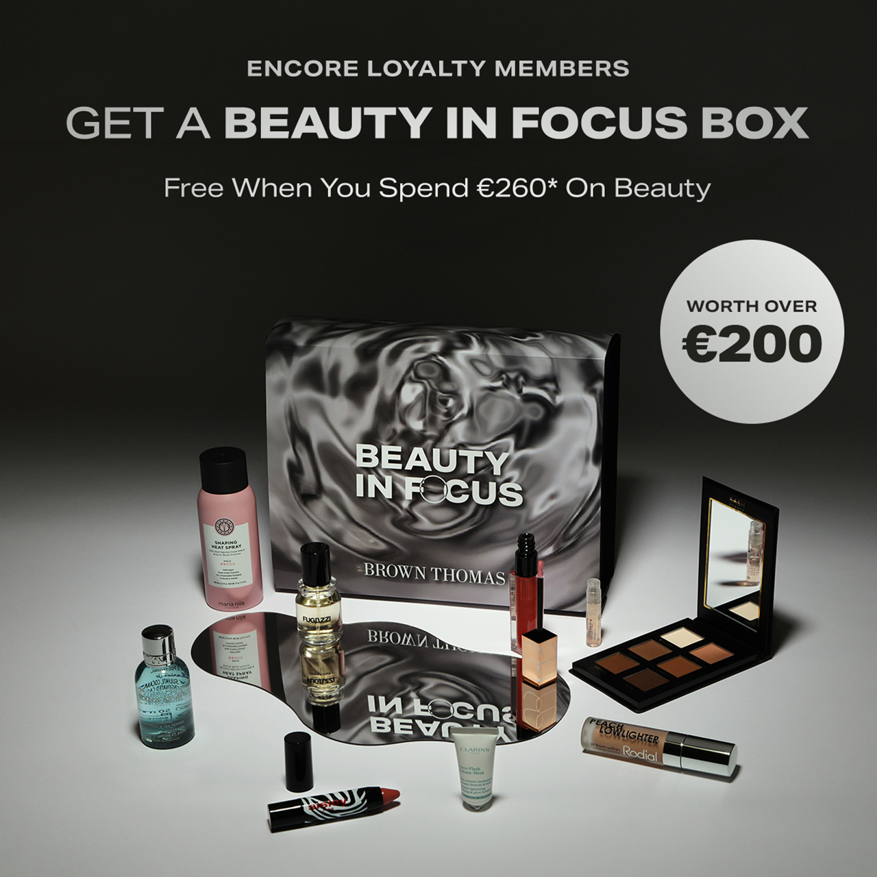 Beauty In Focus box with cosmetics including skincare, fragrance, eyeshadow palette and lipstick. Promotional offer for Encore Loyalty members.