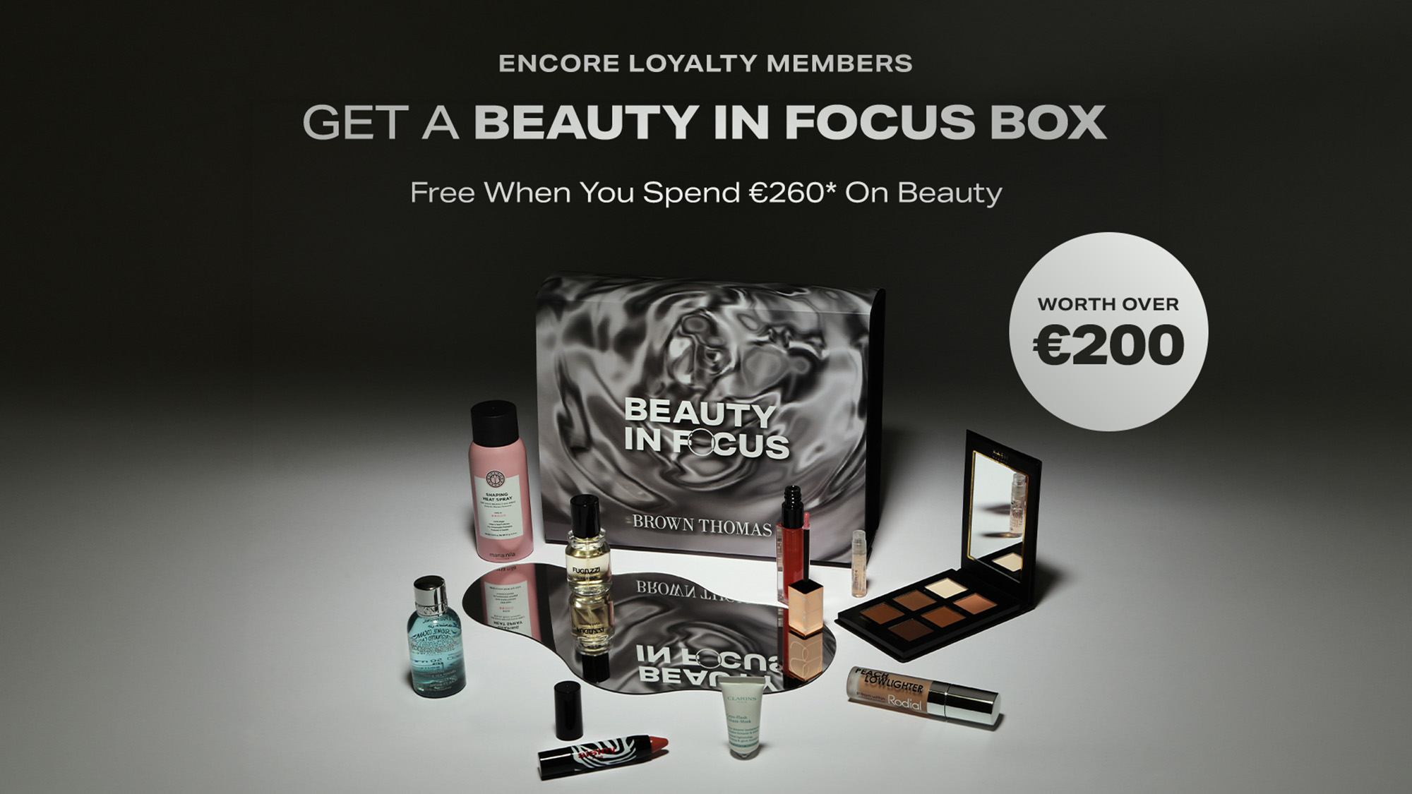 Beauty In Focus box with cosmetics including skincare, fragrance, eyeshadow palette and lipstick. Promotional offer for Encore Loyalty members.