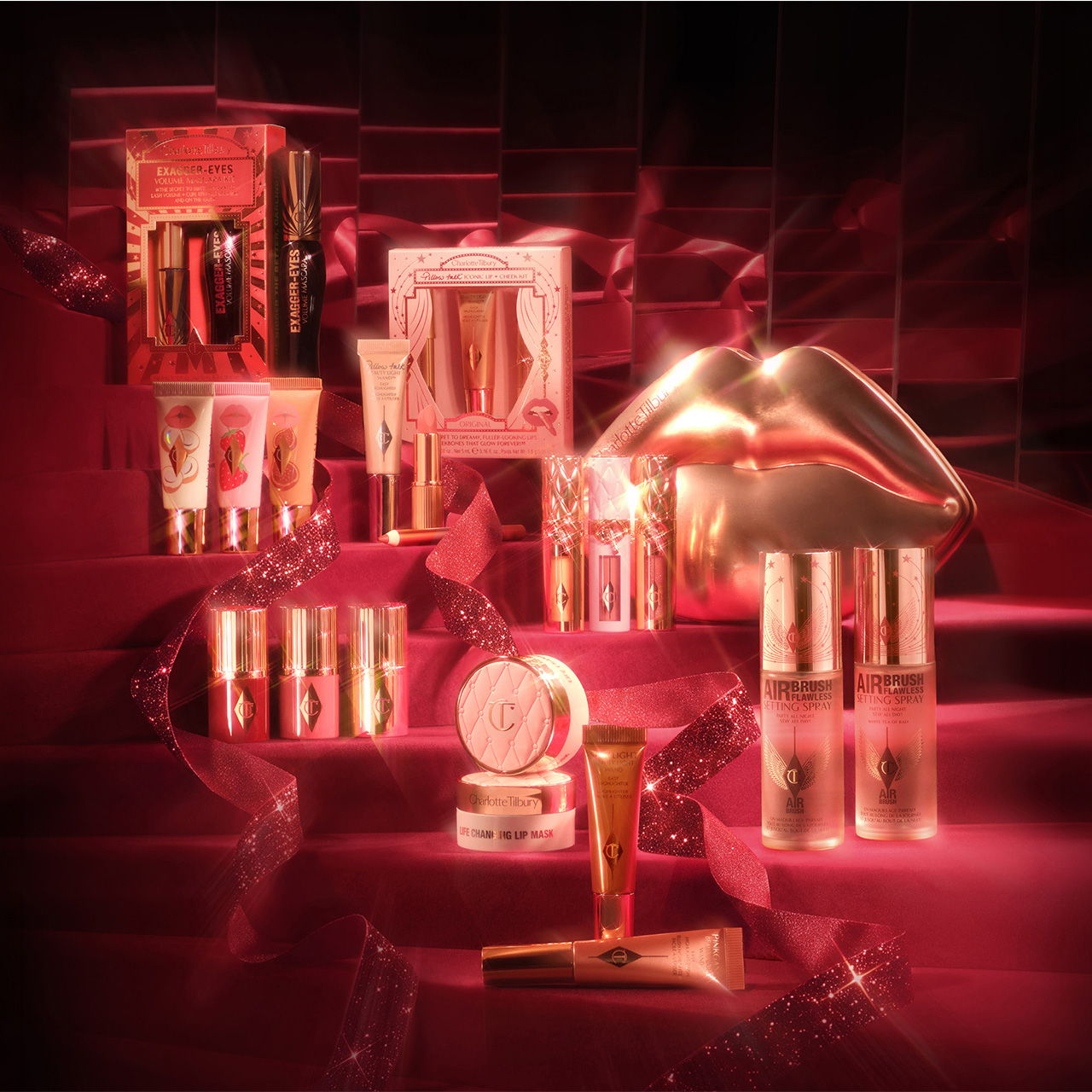 Charlotte Tilbury Christmas beauty collection with red neon lighting including lipsticks, eyeshadows, and gift sets