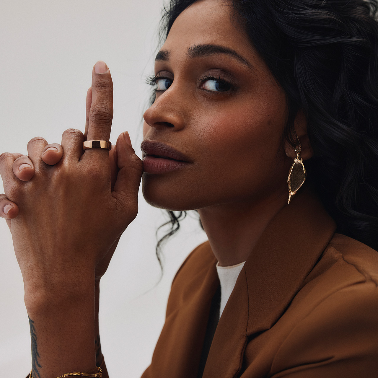 Woman wearing gold band ring on finger, displaying jewellery close-up detail shot