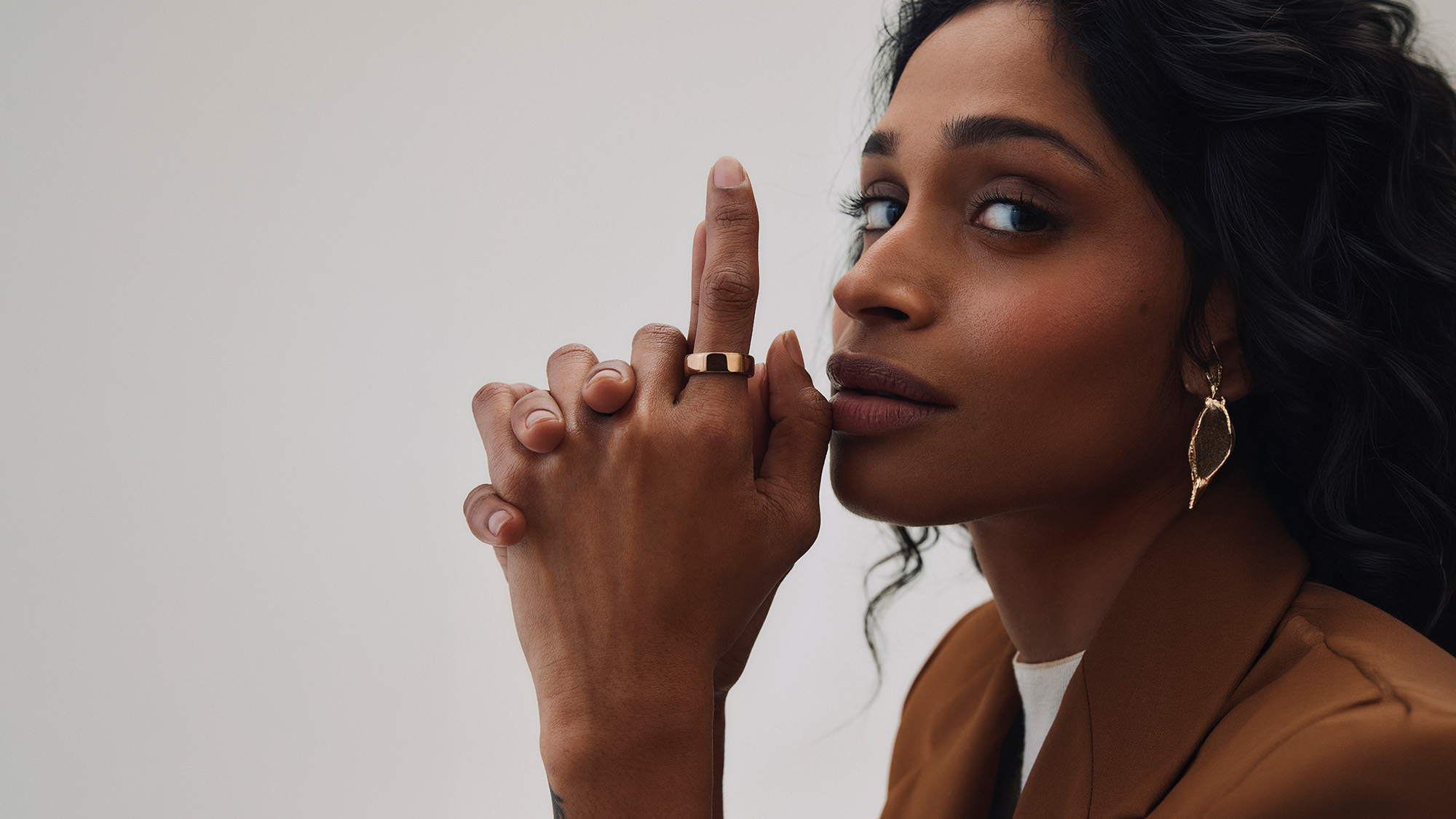 Woman wearing gold band ring on finger, displaying jewellery close-up detail shot