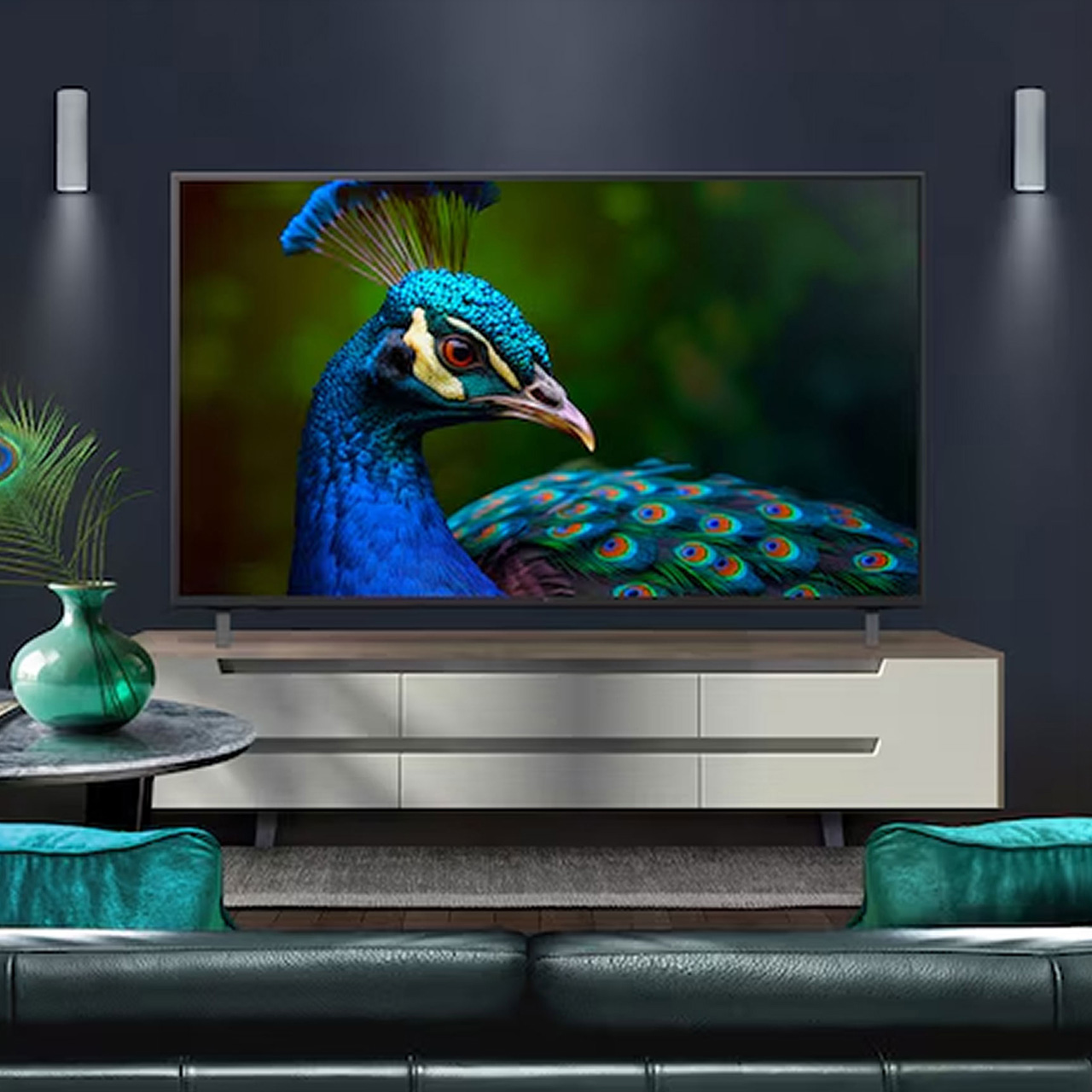 Modern living room with flat-screen TV displaying peacock close-up, white media unit, teal cushions and green vase